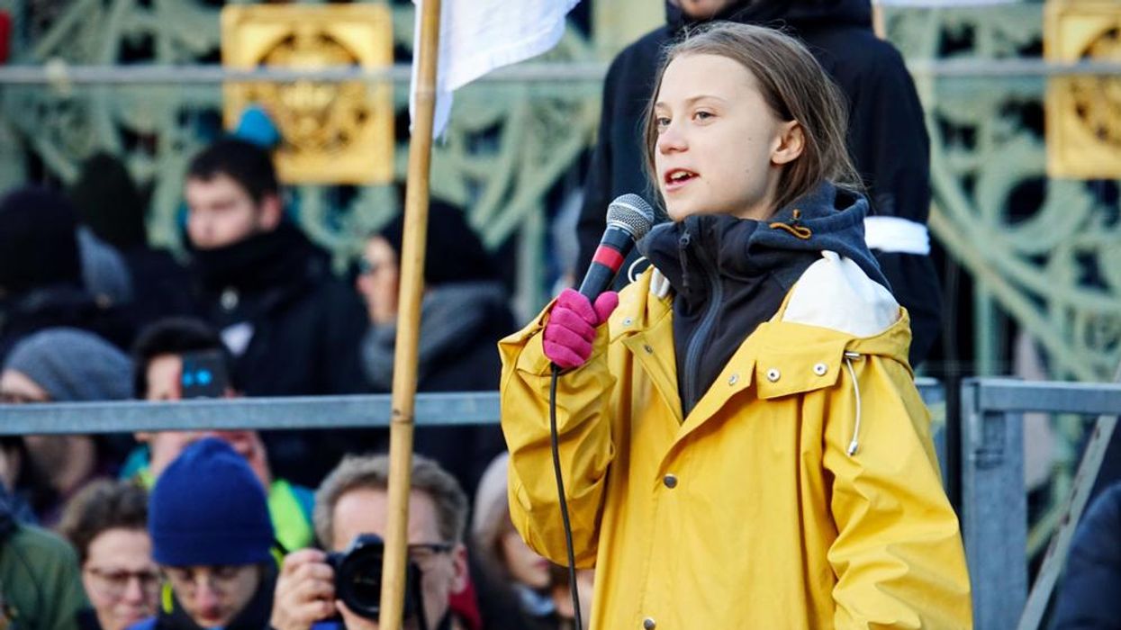 Greta Thunberg speaks into a microphone