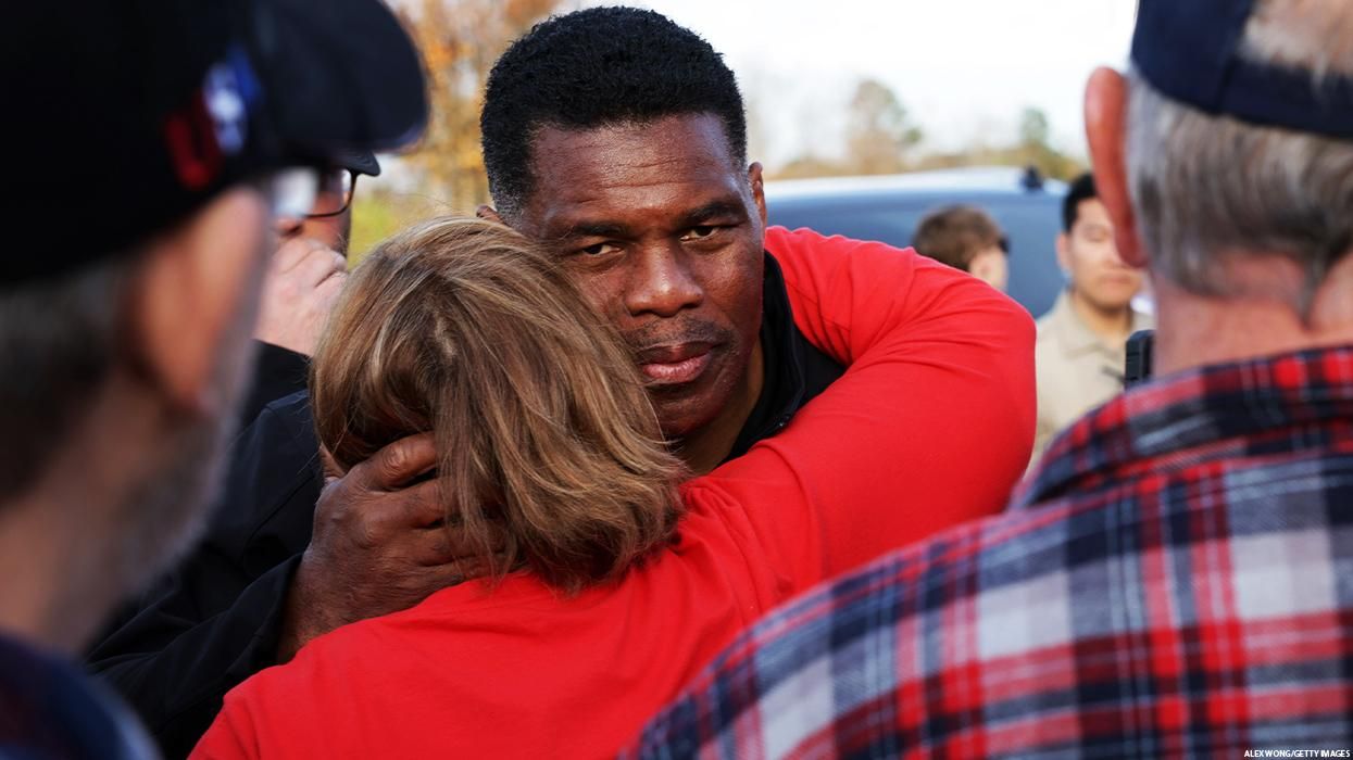 Herschel Walker embraces a woman