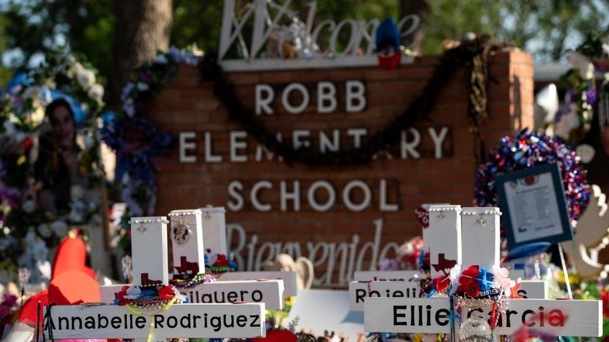 Memorial with flowers and crucifixes outside Robb Elementary School