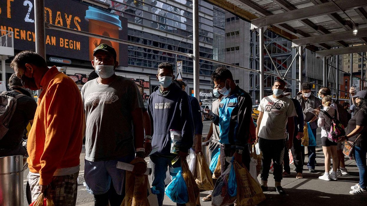 Migrants wait in line on August 10 outside the Port Authority after arriving from Texas.