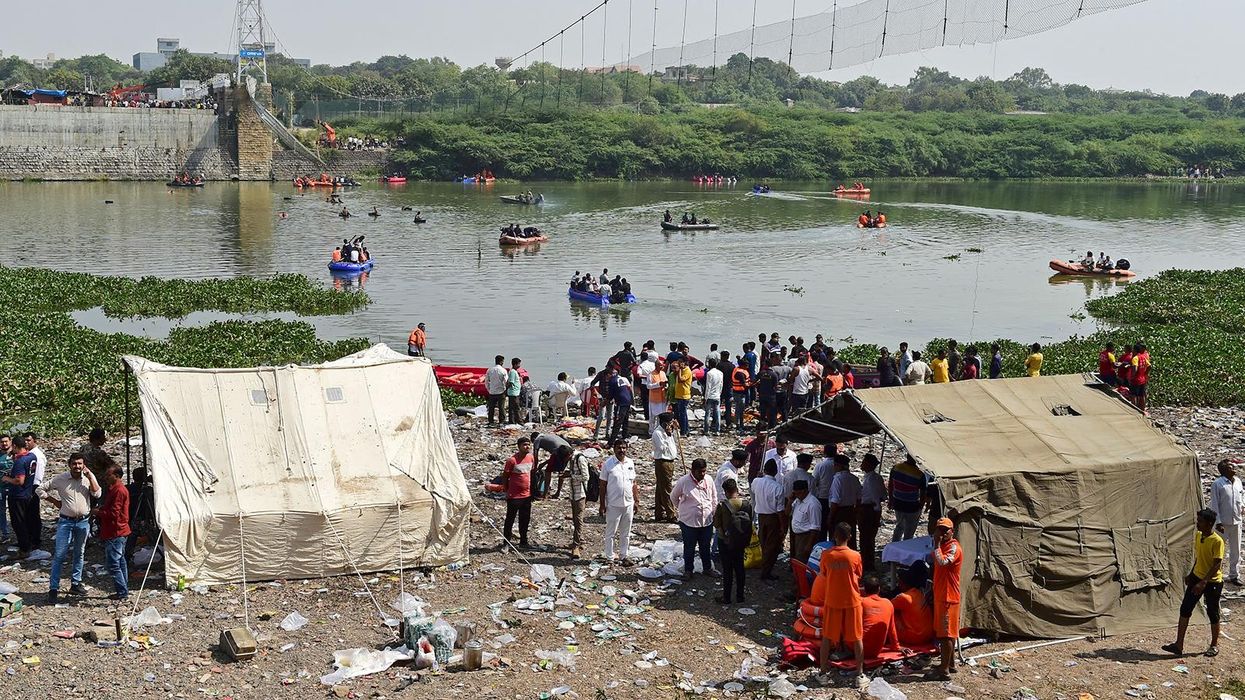 Rescue workers conduct search operations after a bridge across the river Machchhu collapsed at Morbi in India's Gujarat state on October 31.