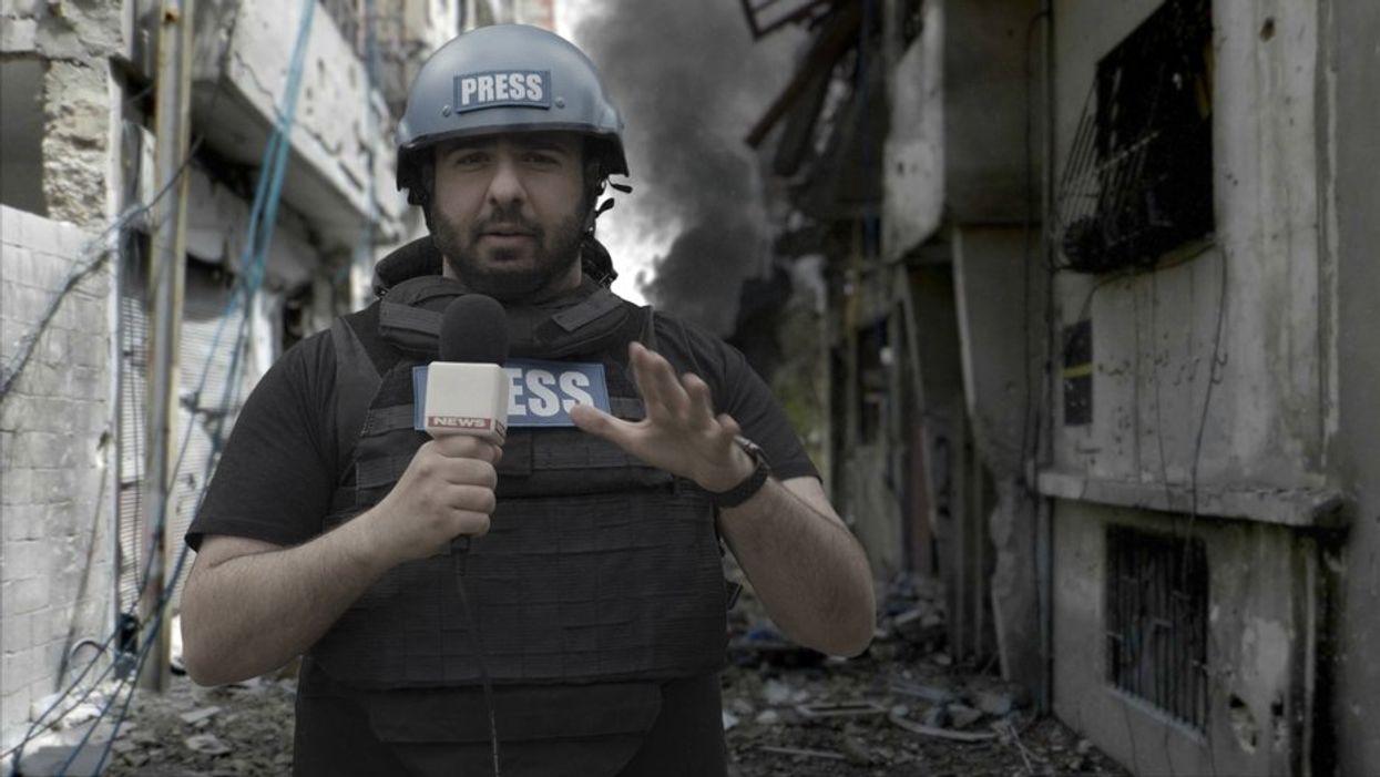 Stock photo journalist reporting from destroyed town